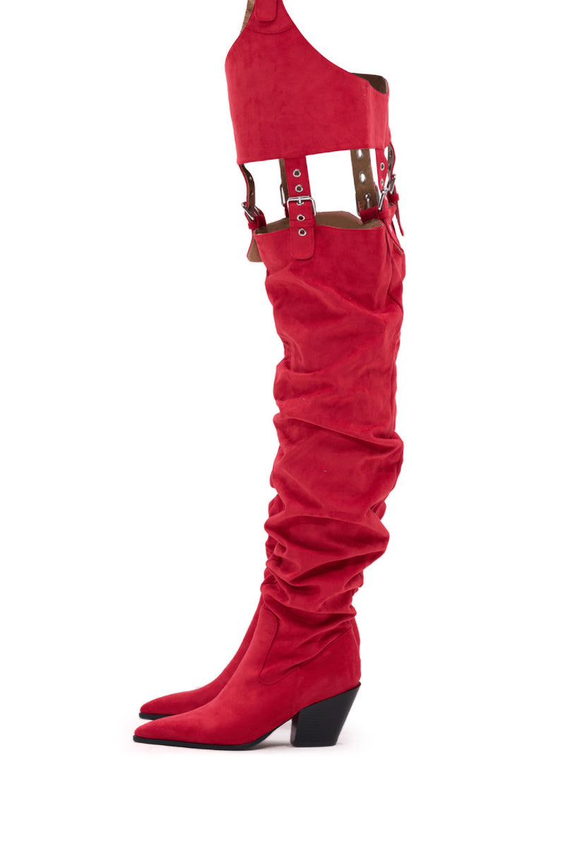 The AZALEA WANG XOMARIA RED FAUX SUEDE WESTERN CHAP BOOT is a tall, slouchy boot featuring a pointed toe, angled heel, and harness-style straps with metal buckles that wrap around the thigh. 9