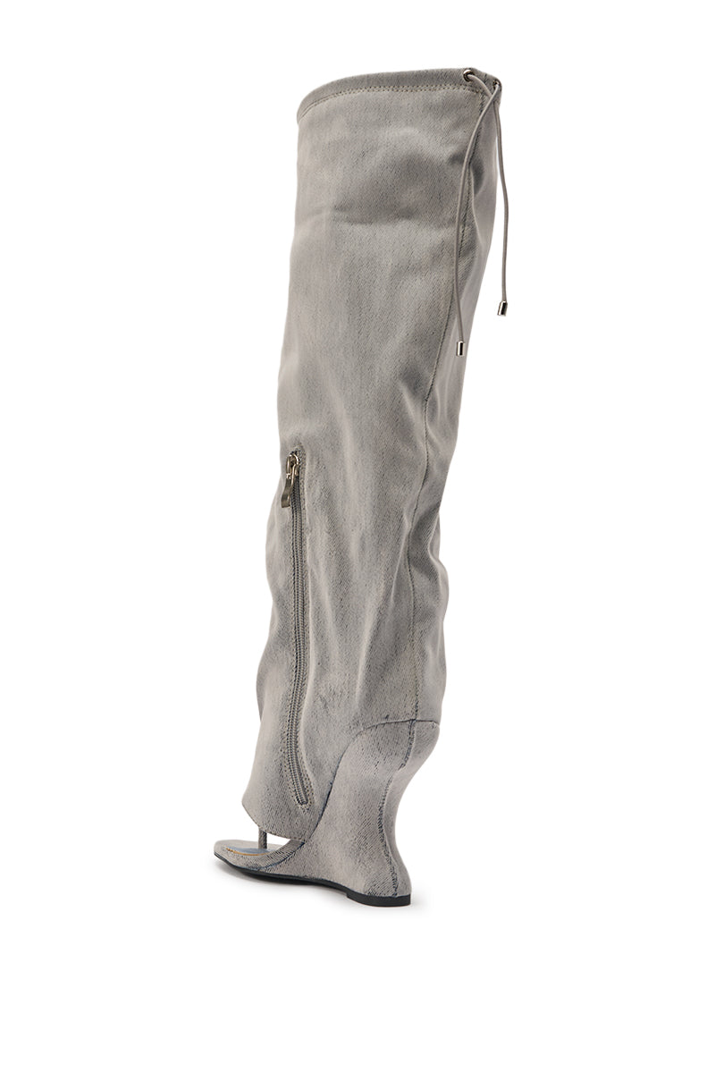 The AZALEA WANG XYLAH Grey Wedge Gladiator Sandal is a high, slouchy grey suede knee-high sandal boot with an open toe, side zipper, wedge heel, and drawstring closure at the top. 8