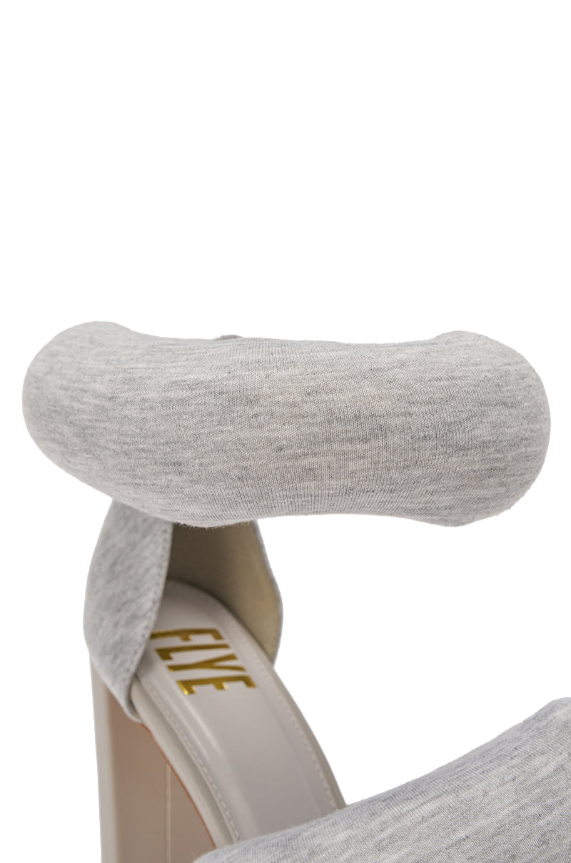 Close-up of the YANIX GREY PUFF SLIP ON SANDAL featuring a chunky heel and a plush, padded gray ankle strap. The word "FIVE" is printed in gold inside the shoe. 6