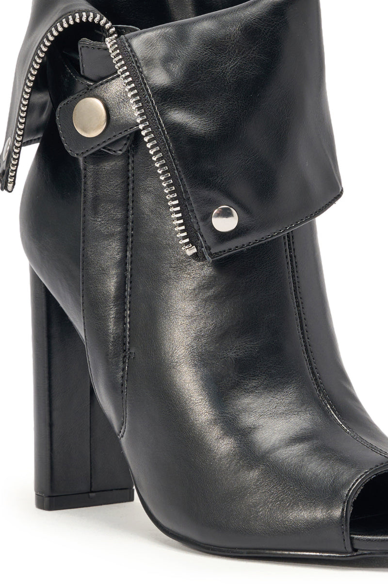 A close-up of the YANIX BLACK PU SILVER HARDWARE CHUNKY HEEL BOOTIE, featuring a folded cuff, silver zipper and snap buttons, ankle-high design, peep toe, and chic chunky block heel in stylish black faux leather. 6
