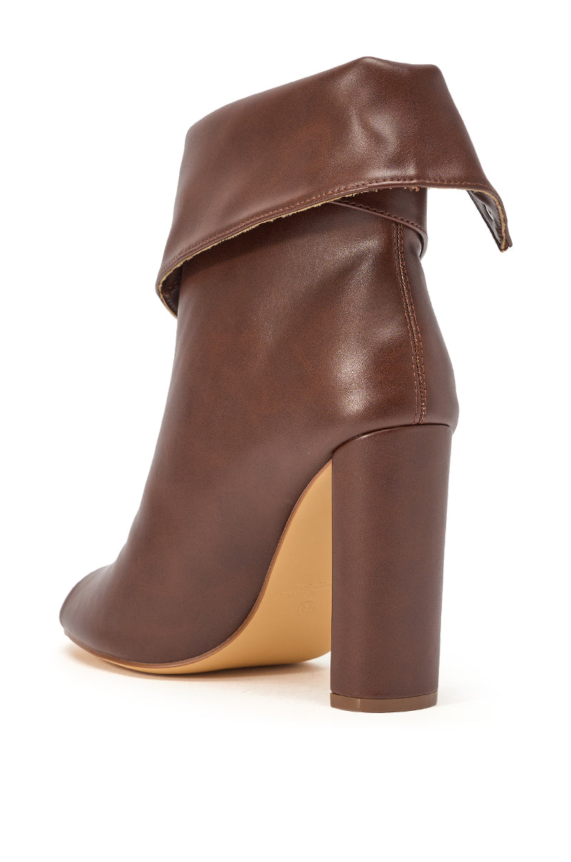 The YANIX BROWN PU SILVER HARDWARE CHUNKY HEEL BOOTIE features brown faux leather, a folded-over cuff, chunky block heel, and silver hardware, shown from a rear side angle on a white background. 6