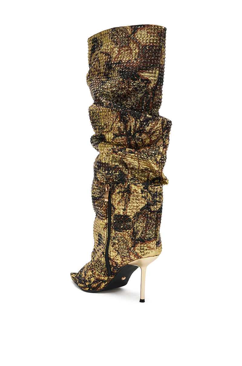 The AZALEA WANG YARDLEY MULTI GOLD RHINESTONE COVERED OPEN TOE BOOT features a tall, slouchy silhouette with sparkling gold and black rhinestones, an open toe, side zipper, and high metallic stiletto heel against a white background.