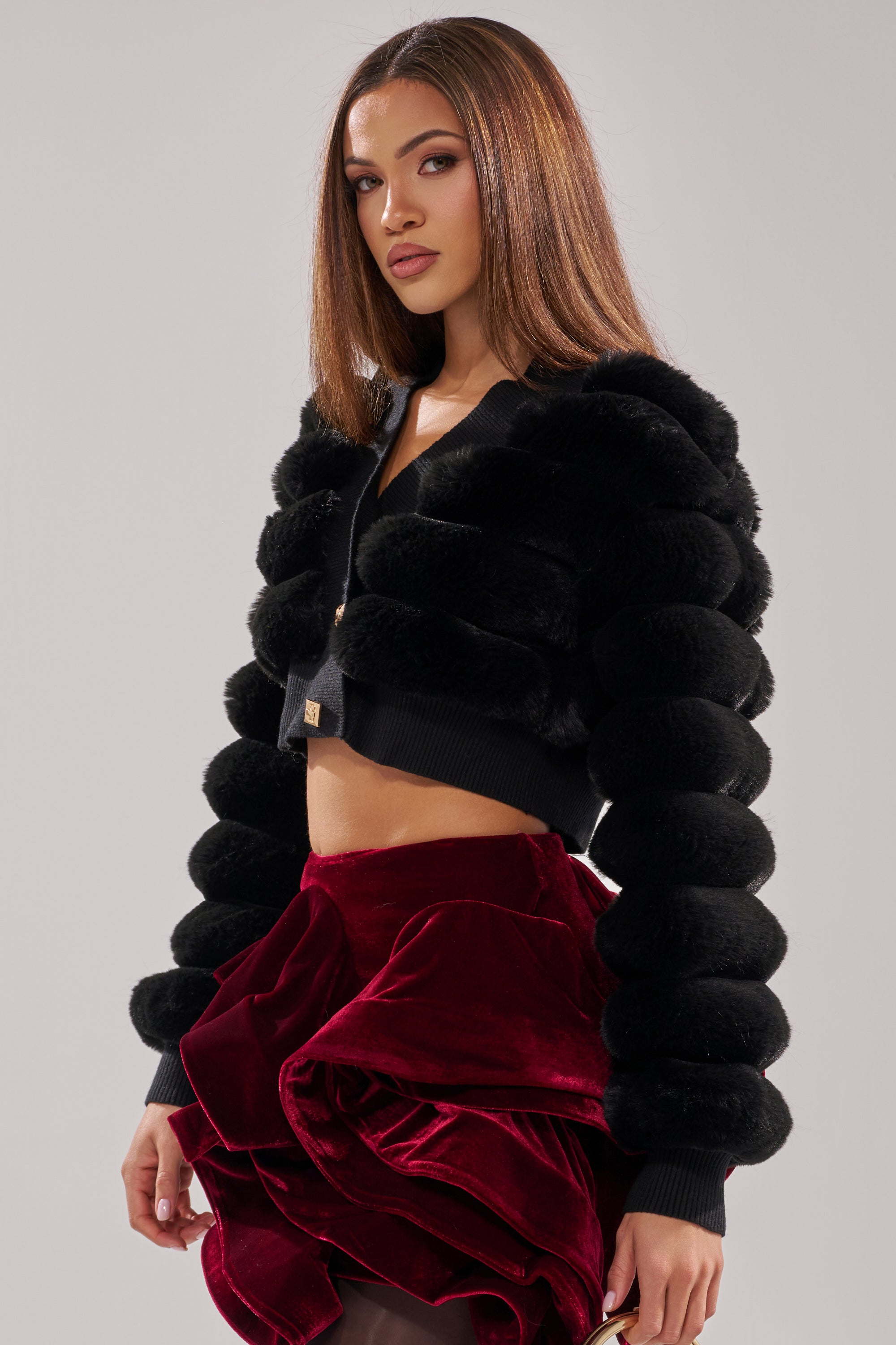 A woman wearing the Wild Heart Faux Fur Cardigan in black. 3