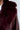 Close-up of a person wearing the luxurious ON THE GO FUR TRIM MOTO IN BURGUNDY jacket. The rich texture of the faux fur collar contrasts beautifully with the material of the coat, capturing a sense of warmth and elegance.