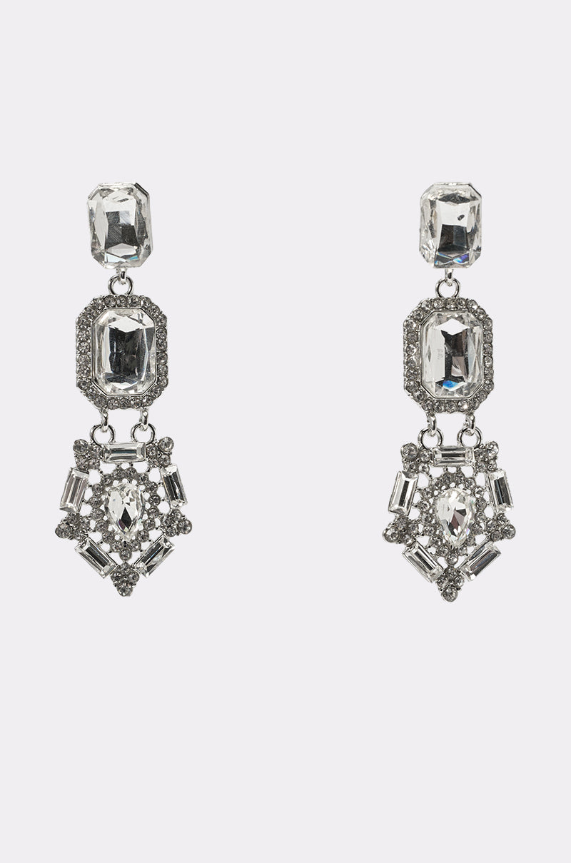 The ART DECO EARRING features ornate silver rhinestone drops with large rectangular clear gemstones and geometric patterns of smaller stones—an elegant choice for any formal occasion. 0