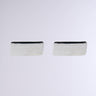 A pair of the MOD EARRING in metallic faux silver is set against a light gray background. These rectangular earrings feature a sleek, minimalist design with a smooth surface and subtle shine, making them ideal for any modern ensemble.