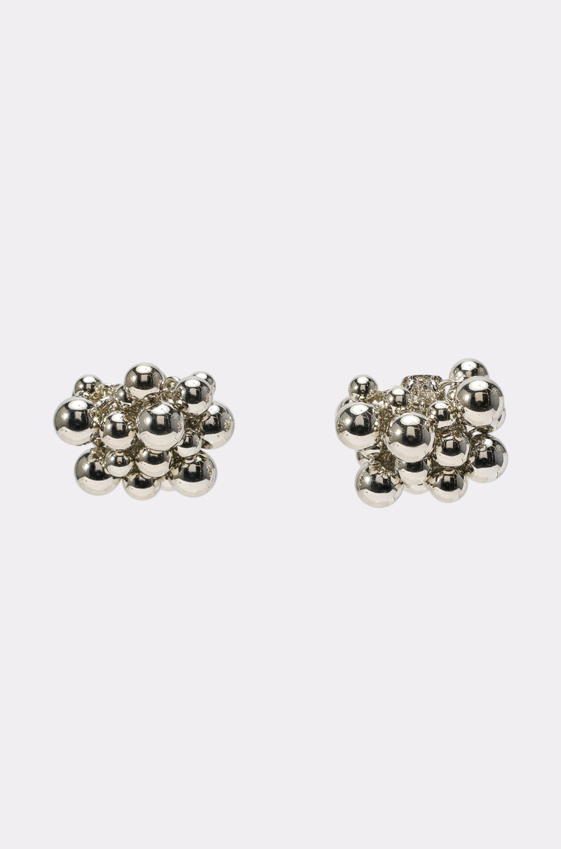 The BUBBLES AND BRUNCH SILVER EARRING showcases shiny silver spheres clustered together, making a striking statement piece for contemporary accessory lovers. Displayed on a white background, these earrings are perfect for modern style enthusiasts. 0