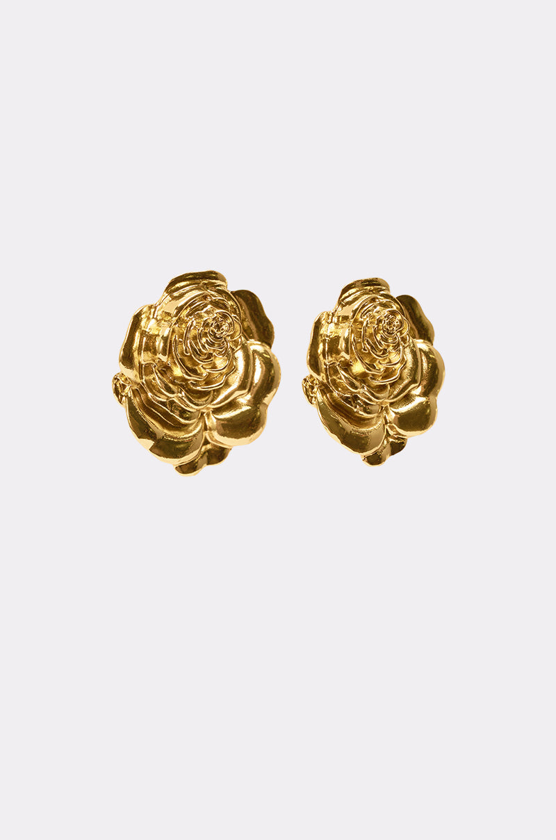 The IN BLOOM EARRING is a pair of gold earrings shaped like blooming roses, shown against a plain light gray background. 4