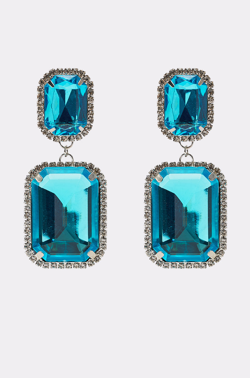 ON TREND EARRING: Dangling silver earrings with large rectangular blue gemstones bordered by rhinestones, topped with a matching smaller blue gemstone. 3
