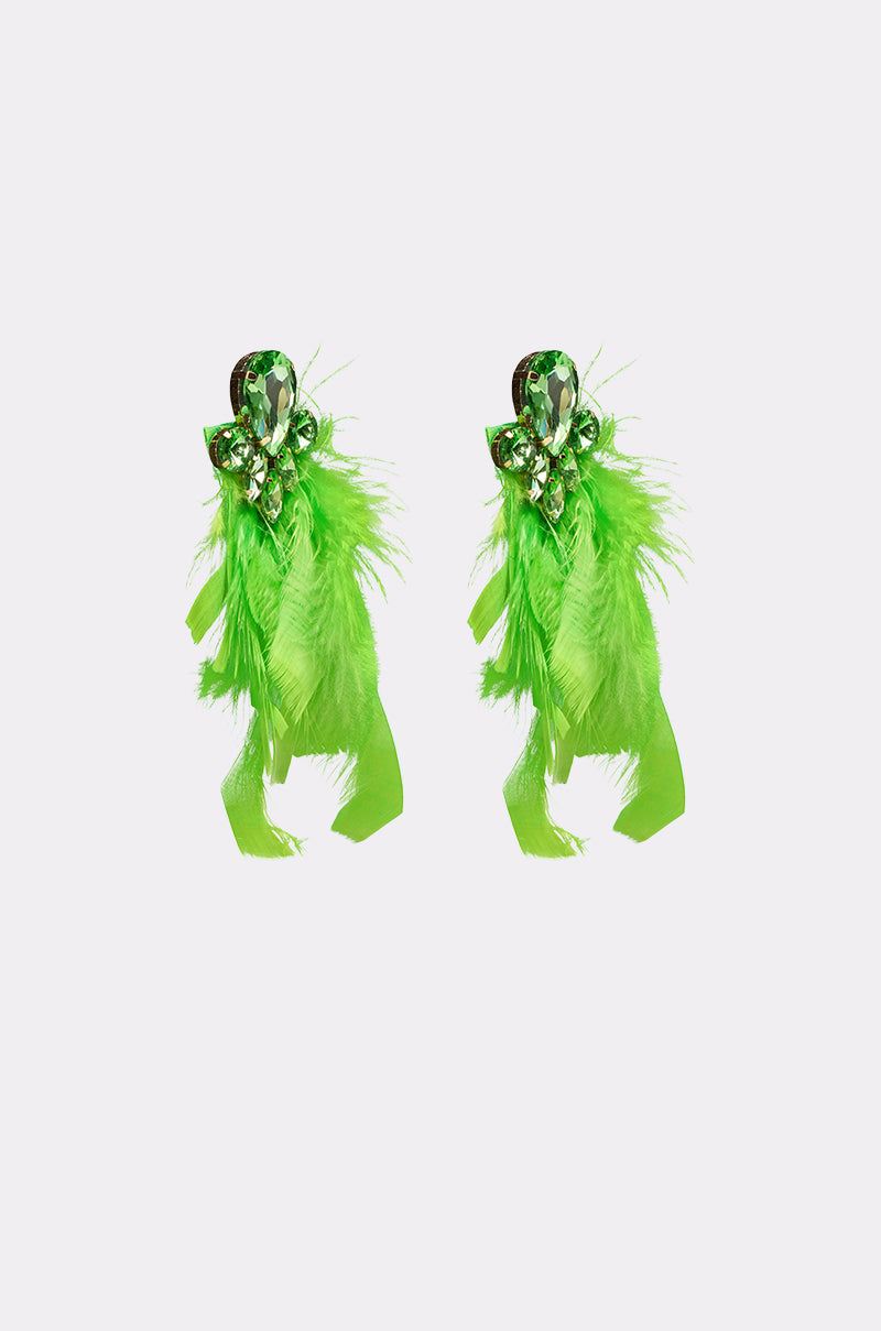 The SHOW IT OFF EARRING is a pair of vibrant emerald-green earrings with shiny gemstones and cascading feathers, showcased against a plain white background. 3