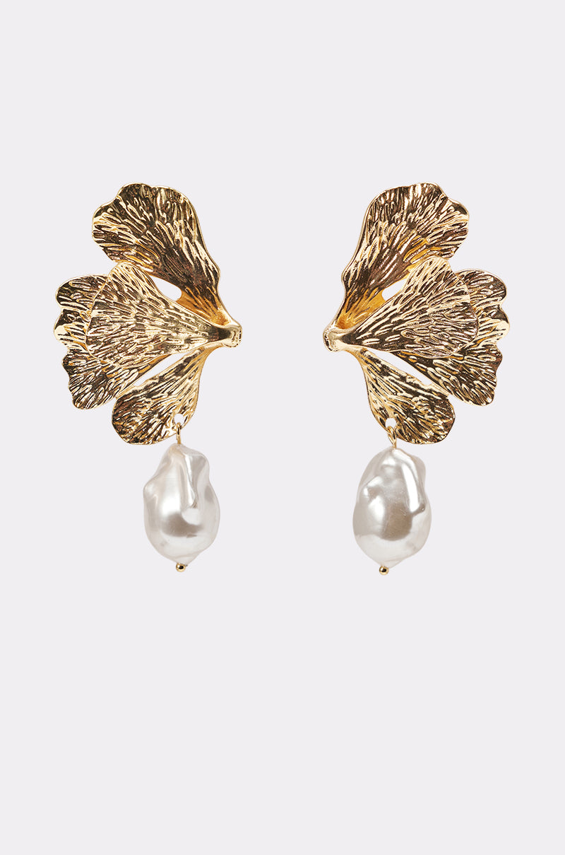The ON THE BEACH EARRING features gold-tone ginkgo leaf-shaped statement earrings with textured detailing and dangling irregular faux pearls, displayed on a plain white background. 1