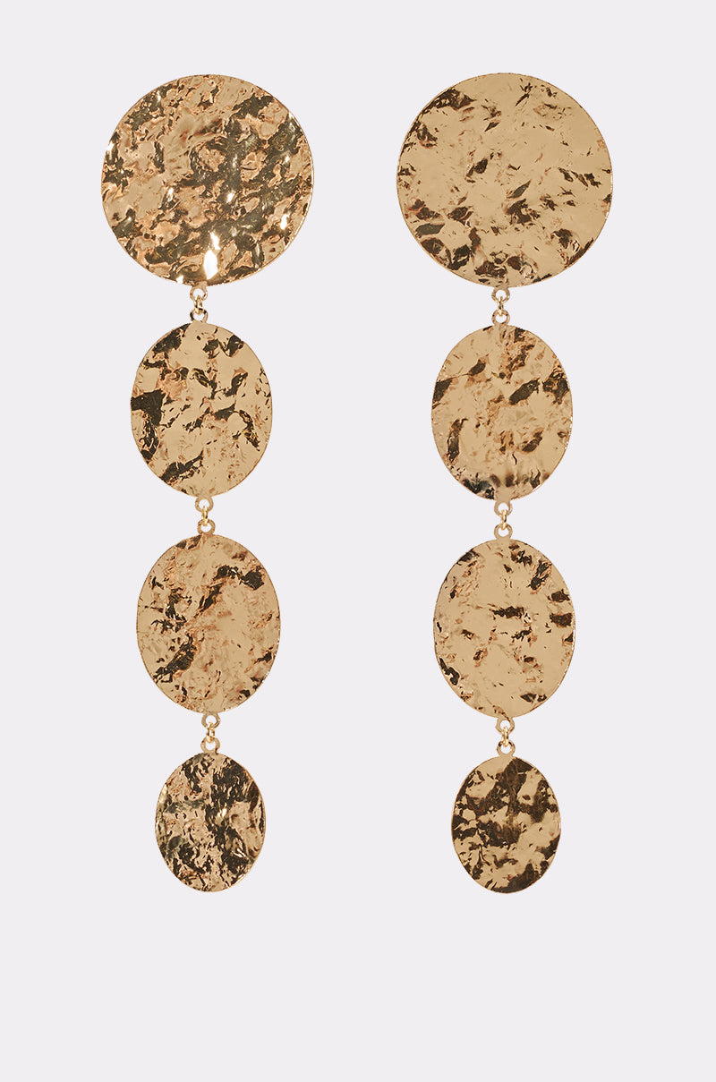 The IN THE SUN EARRING features four gold hammered discs connected vertically for a cascading effect—ideal vacation jewelry, shown on a light background. 0