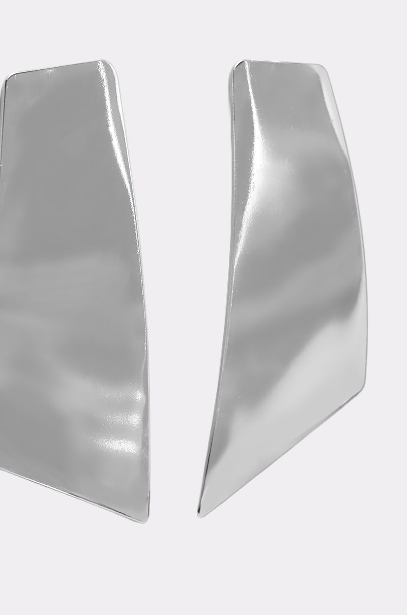 The ON YOUR FEED EARRING is a pair of sleek, silver-tone statement earrings with asymmetrical, shiny, and slightly curved geometric shapes—perfect for a modern look. 3