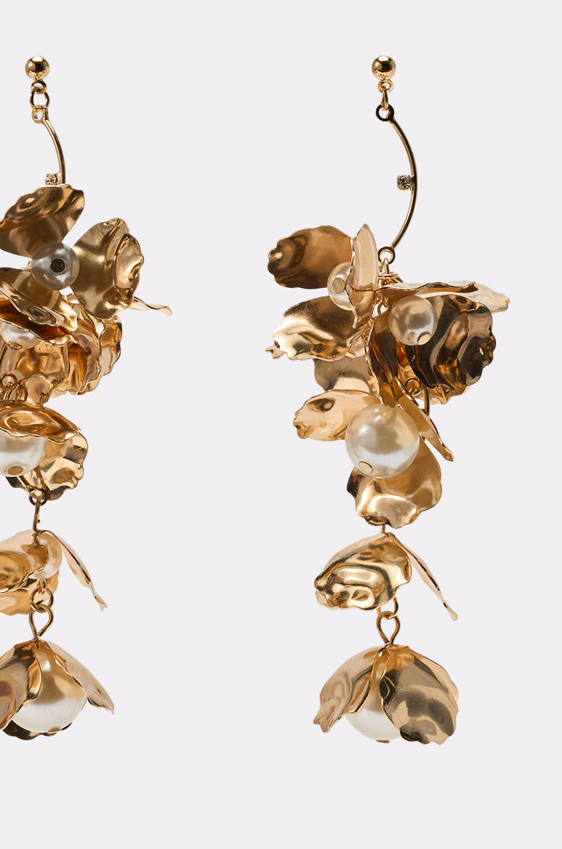 NOT THE NORM EARRING: Gold drop earrings with layered, sculpted floral designs and pearl accents, displayed on a plain white background. 2