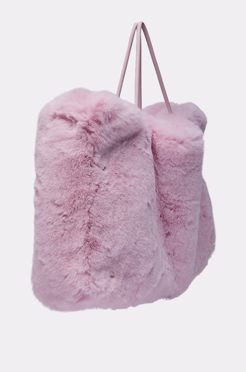 The BB GURLLLL FAUX FUR TOTE is an oversized handbag in cotton candy-colored faux fur with two thin pink shoulder straps, displayed against a plain light background. 5