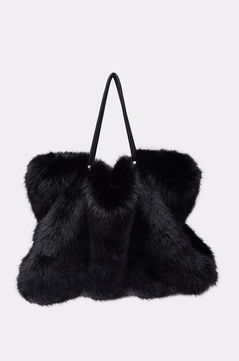 The YETI LARGE FAUX FUR TOTE IN BLACK features plush faux fur and two black handles, shown against a white background—a bold, oversized handbag for standout style. 2
