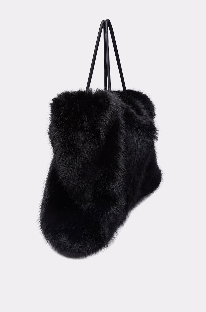 The YETI LARGE FAUX FUR TOTE IN BLACK features a spacious design, plush black faux fur construction, and slim handles—ideal for anyone seeking a luxurious, oversized handbag. Displayed against a plain light gray background. 3
