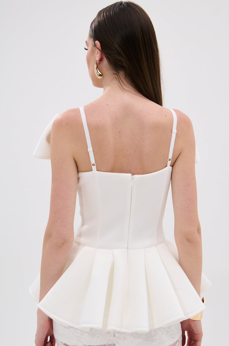 A woman with long brown hair, gold hoop earrings, and a white DANCE AROUND SLEEVELESS PEPLUM CORSET is shown from the back against a plain background. 3