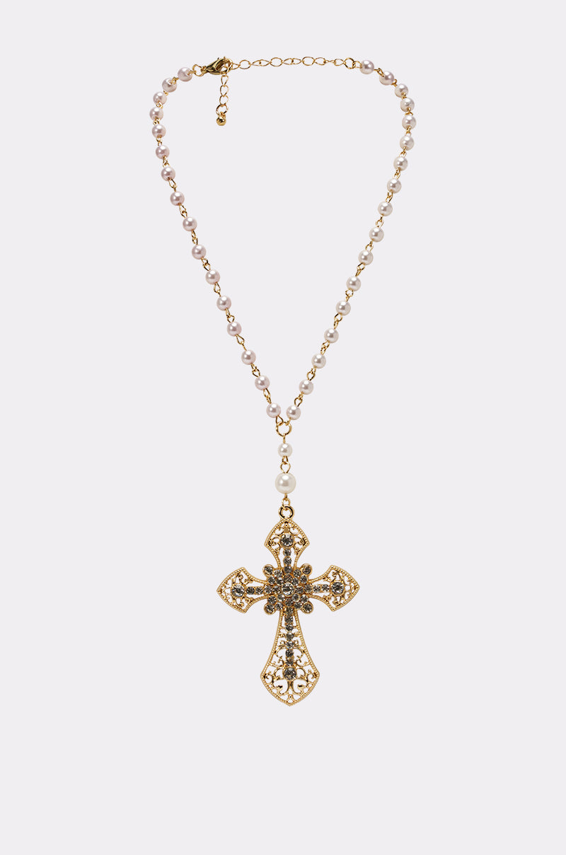 The PRAYERS UP NECKLACE is a gold pearl chain rosary with a strand of pearls and a large, intricately detailed cross pendant, shown on a plain white background. 0