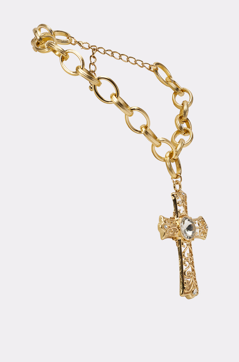 The ALL MY LOVE NECKLACE features a gold chain with large, textured links and a decorative filigree cross pendant accented by a clear gemstone, elegantly displayed on a light background. 2