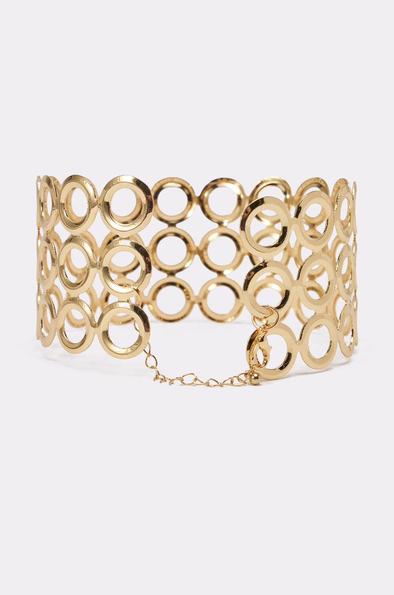 The TITI NECKLACE is a gold choker with interlocking open circles in three rows of links and a delicate chain clasp, shown on a plain white background. 4