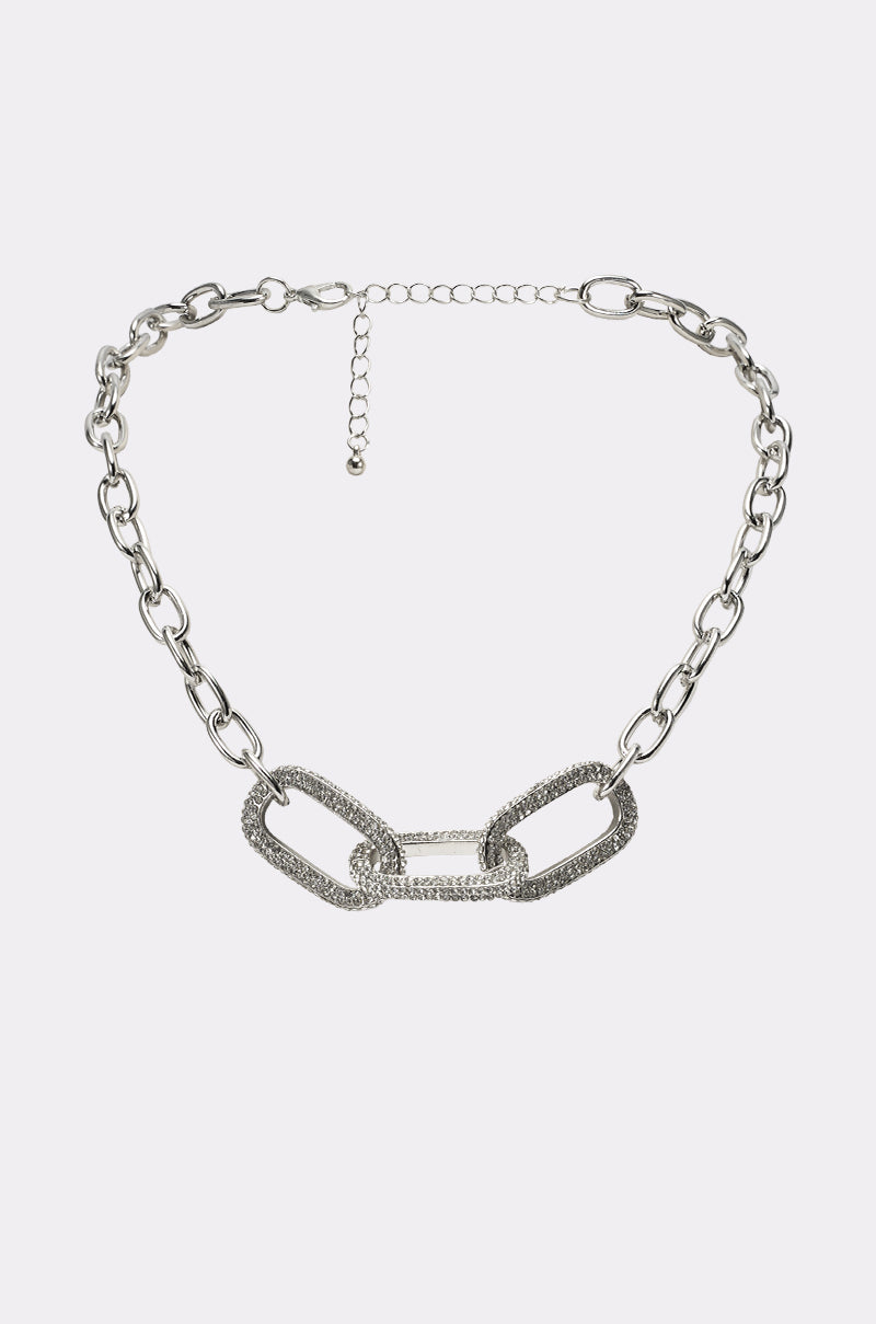 The YA GET ME NECKLACE showcases large textured links with sparkling stones at the center, accented by smaller plain links along a silver chain, and is finished with an adjustable clasp closure at the top. 0