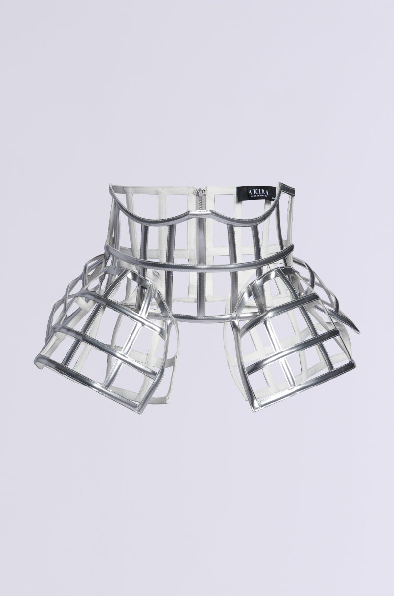 The ULTIMATE TEASE METALLIC CAGE BELT showcases a geometric design with a structured waistband and flared grid sections. Its peplum silhouette gleams in silver, accented by a small black tag and white text on the waistband.
