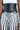 Someone is wearing vertically striped black and white pants with a BUCKLE UP PU BELT, a wide Western-inspired black belt featuring two silver buckles cinching at the waist. Their top is partially visible and white against a plain background.