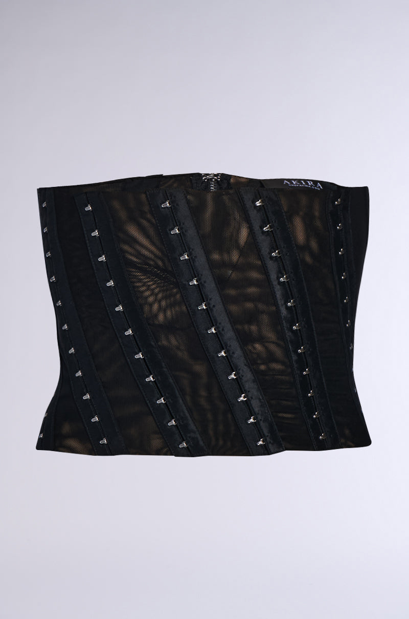 A corset in black showcases sheer panels and vertical boning, with small silver hook-and-eye closures and faux leather trim as accents. To achieve the perfect fit, it includes the CINCH ME UP STRETCH BELT, made from stretchy double-lined mesh for a stylish yet comfortable feel. 0
