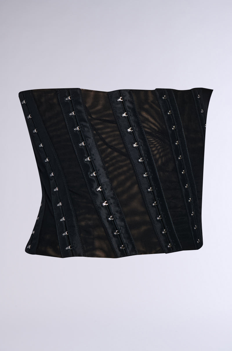 The CINCH ME UP STRETCH BELT is a black belt featuring vertical boning and numerous small metal clasps, set against a light gray background. The material showcases stretchy double-lined mesh with a sheer, slightly shiny finish, offering a structured yet elegant appearance. 4