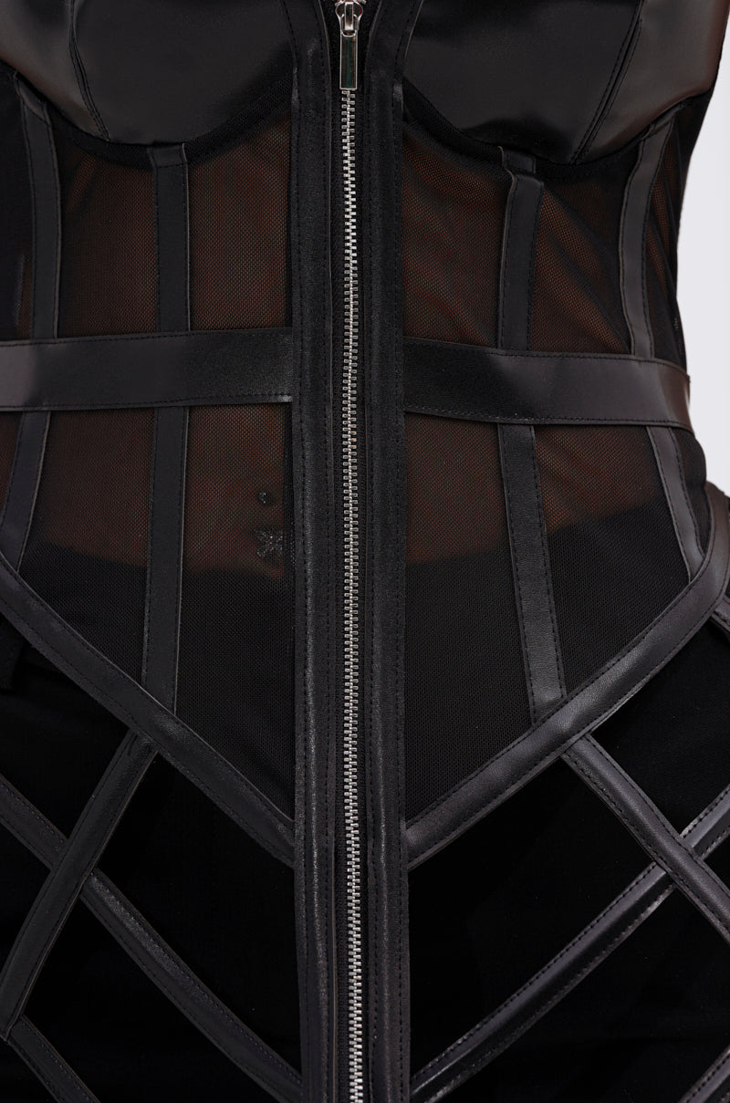 Close-up of the ALL THE DRAMA CUT OUT CORSET, a black piece with sheer mesh panels, structured faux leather boning, a silver center zipper, and geometric lines for an edgy, modern vibe.