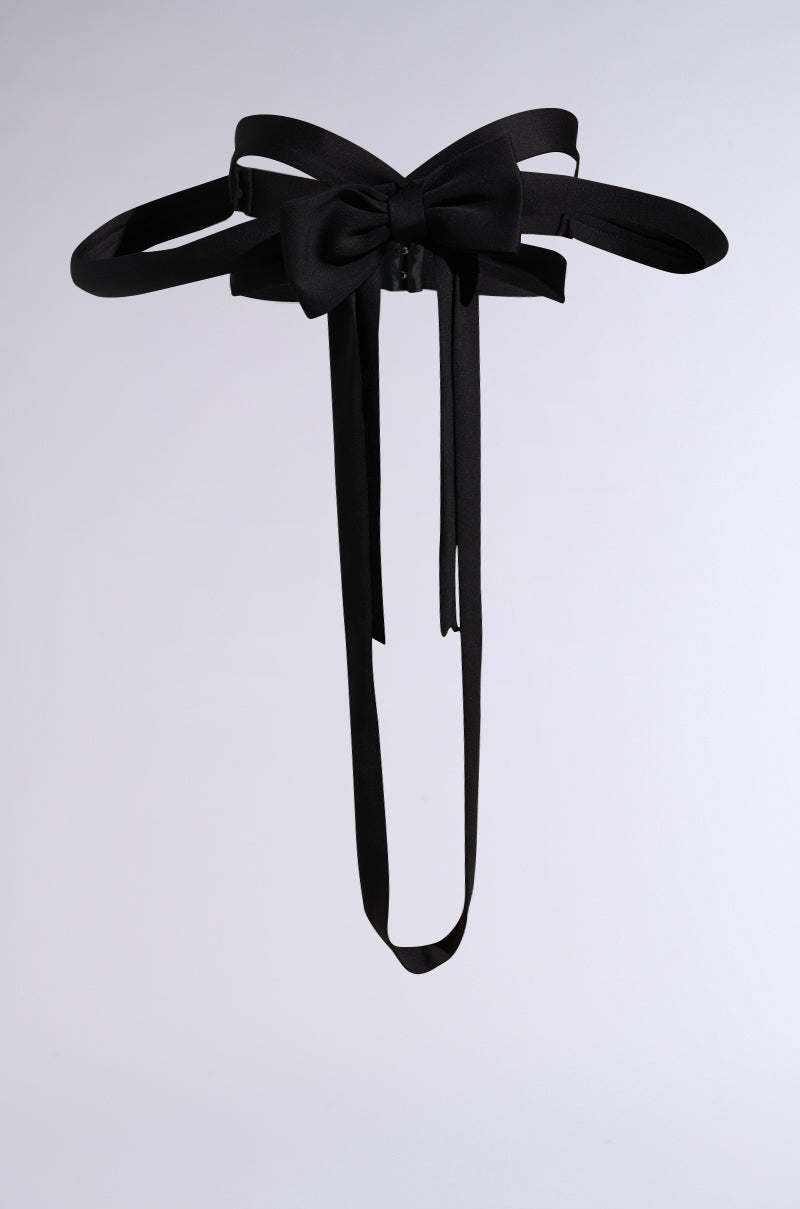 The IM THE GIFT CHEST PIECE is a black satin bow belt with long ribbon tails, shown on a plain light grey background. 7