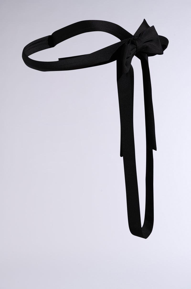 The IM THE GIFT CHEST PIECE is a black fabric belt featuring a bow with long, trailing ends, shown against a plain light gray background. 8