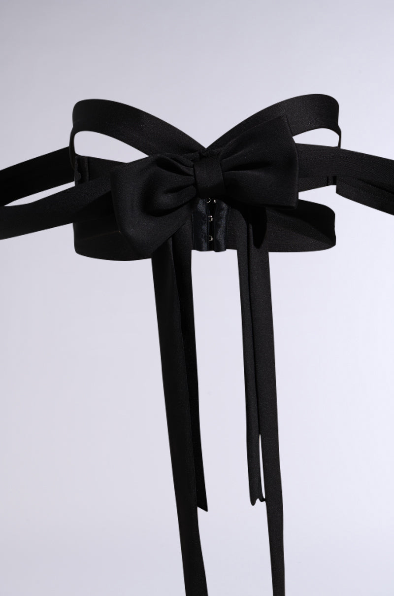 The IM THE GIFT CHEST PIECE is a wide black satin belt featuring a large, elegant central bow and long trailing ribbon ends, showcased against a plain light background. 9