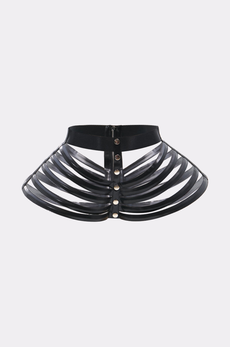 The DRAMA STRETCH CAGE BELT is a black, structured faux leather accessory with curved rib-like straps and metallic front buttons, resembling a stylized skeletal rib cage.