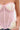 A person wears the GOING PLACES CORSET WITH TWEED, a strapless top in pastel plaid tweed with pink mesh panels, visible boning, and frayed trim. The image is cropped at their shoulders and waist.