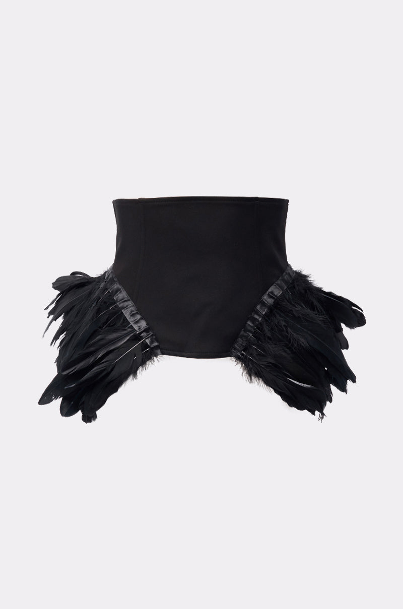 The LIKE A SWAN FEATHER BELT is a black peplum belt with corset-style waist-cinching and two side panels of black feathers, shown against a plain light background.