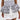 A person wears a white dress with polka dot and striped ruffled peplum corset, finished with the POLKA DOT IT BELT for a playful touch, featuring layered ruffles in both polka dot and striped patterns.
