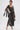 A woman stands confidently in the ONLY ONE OF ME RHINESTONE MIDI DRESS, featuring geometric cutouts and sparkling rhinestone details.