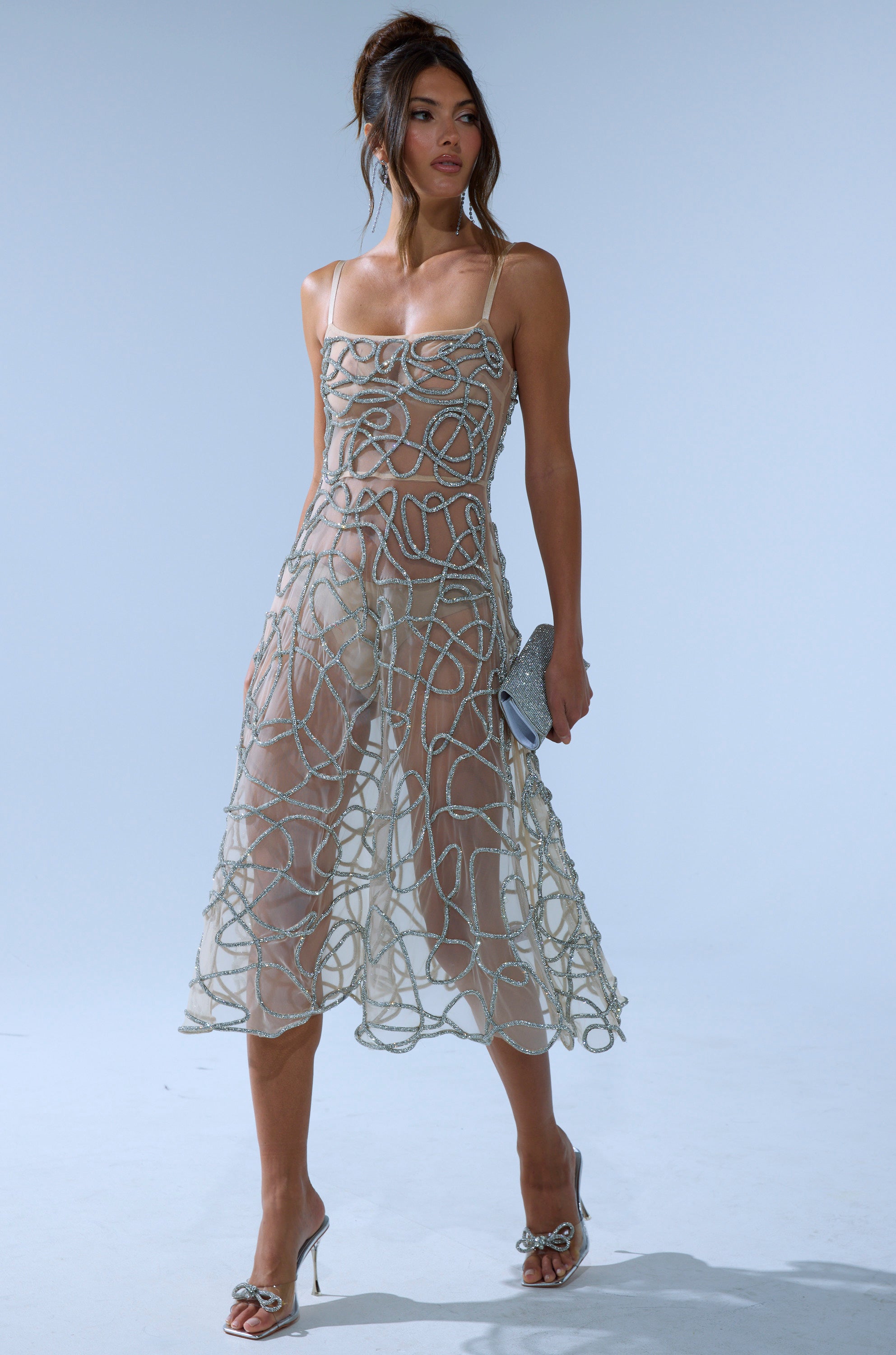 A woman wearing the RIGHT THIS WAY RHINESTONE MIDI DRESS in nude.