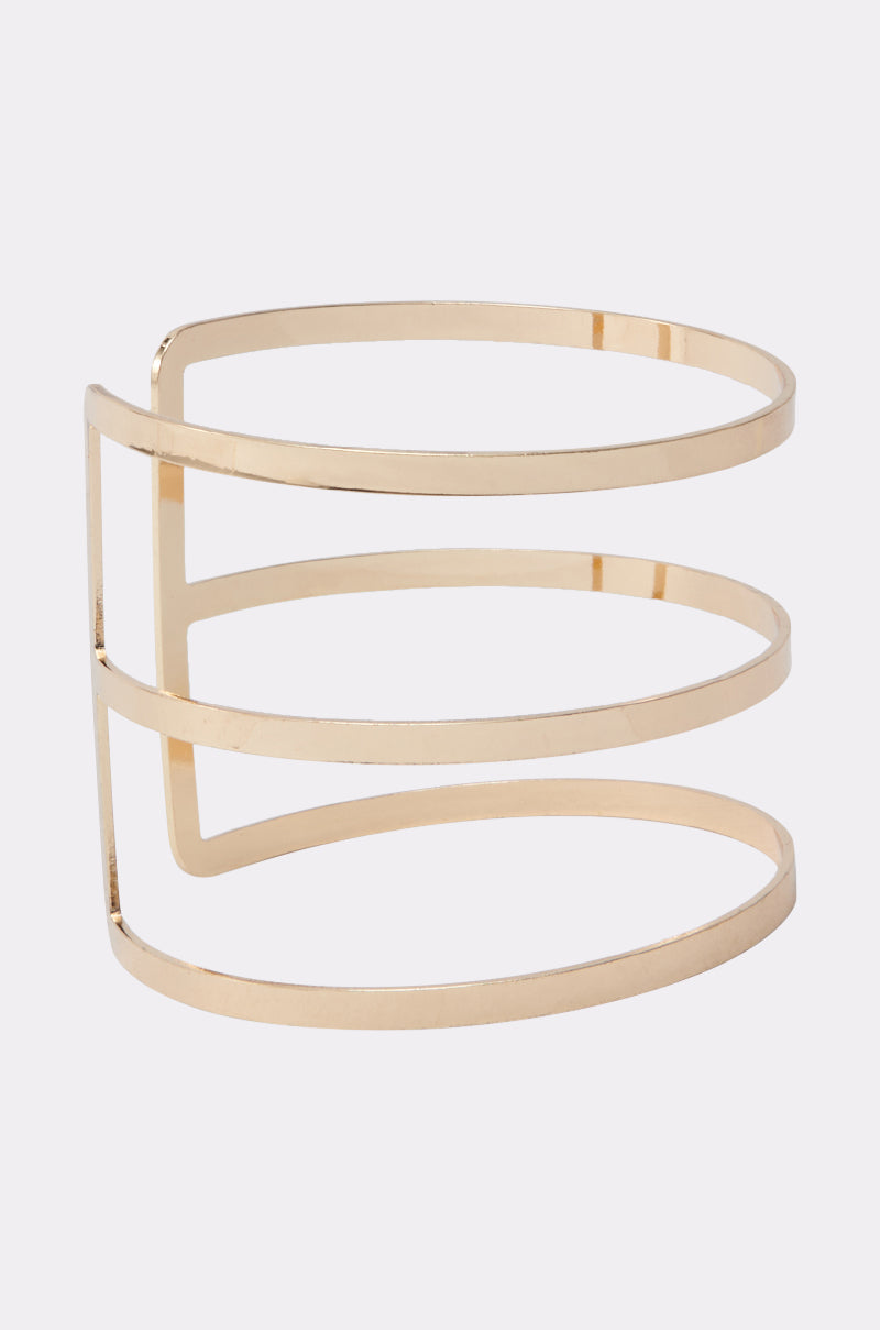 The STRICTLY BUSINESS ARM CUFF features three parallel faux gold bands joined by a vertical bar on one side for a modern geometric look, finished with a shiny polish—an ideal accessory for elevating any outfit. 2