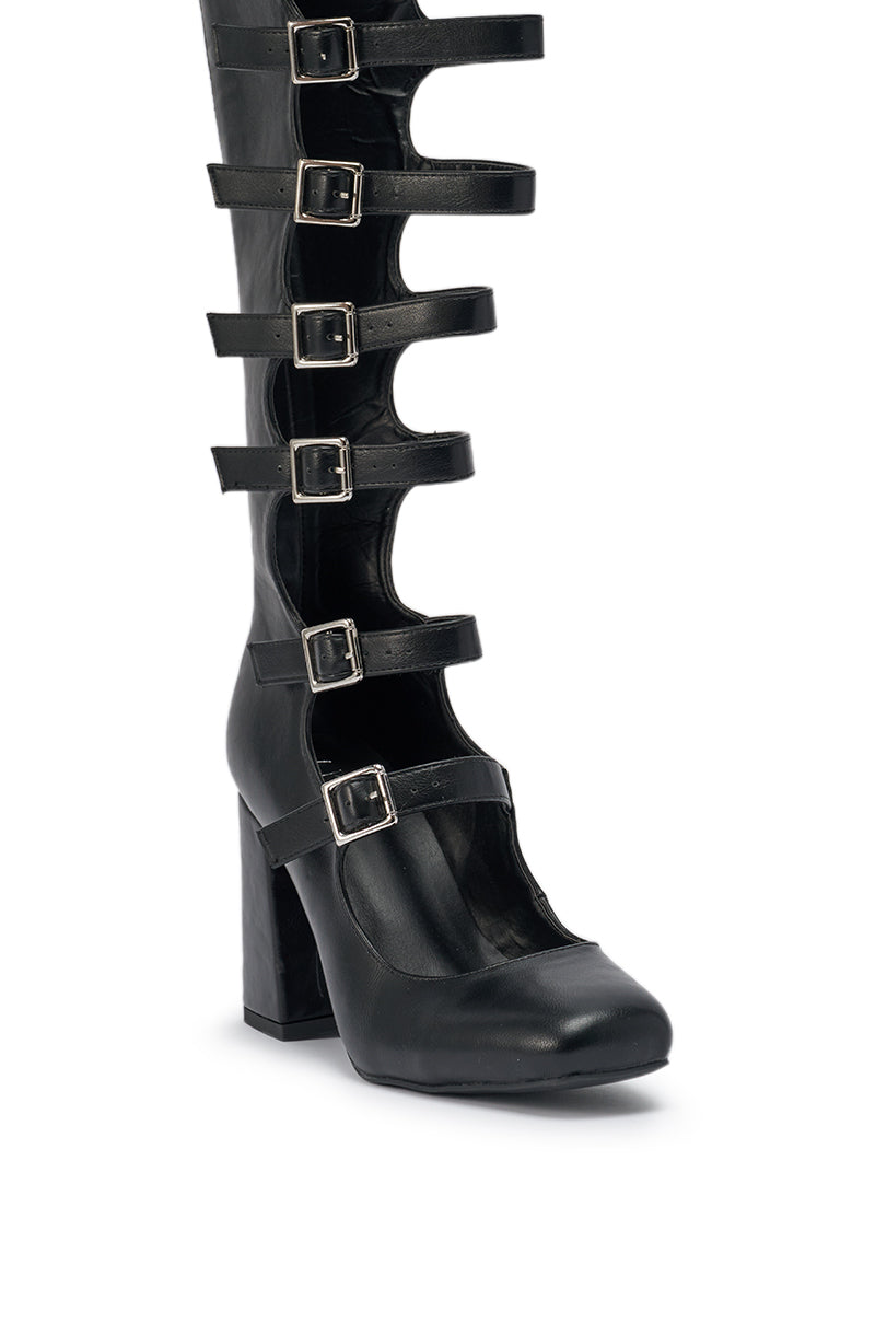 The AKIRA GOLD YVETTE BLACK OVER THE KNEE MARY JANE BOOT is a black, closed-toe boot with multiple horizontal straps and silver buckles, featuring a chunky block heel and reaching over the knee. 9