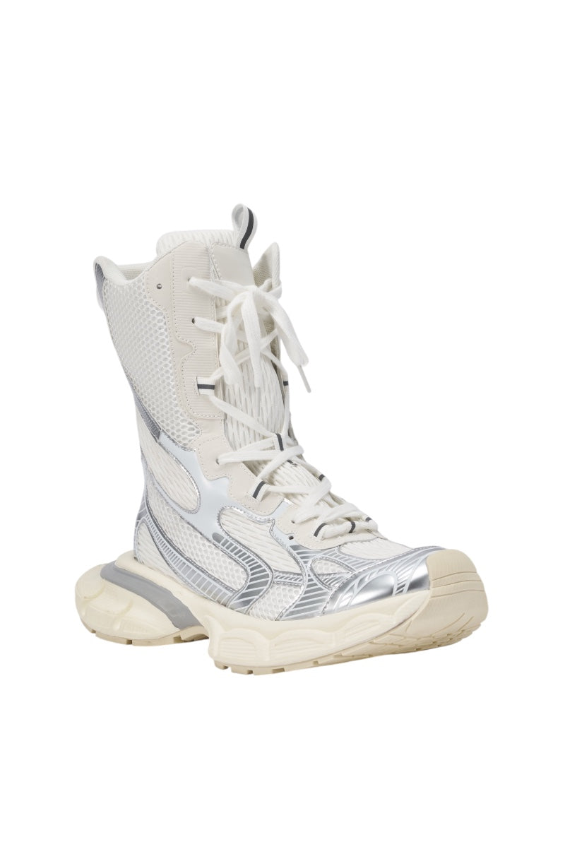 The AZALEA WANG YVONNE WHITE LACE UP SNEAKER is a metallic high-top in white and silver with mesh and leather details, a chunky beige sole, white laces, and futuristic accents—ideal for those wanting bold, modern sneaker boots. 4