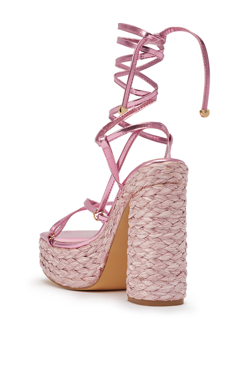 The AKIRA GOLD ZAIDEE PINK PLATFORM RAFFIA LACE UP SANDAL features metallic pink faux leather ankle straps and a thick woven block heel. 6