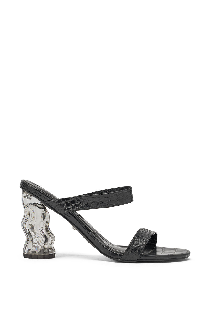 The AKIRA GOLD ZARIA BLACK CLEAR HEEL SLIP ON SANDAL features black crocodile-embossed faux leather, two straps, and a distinctive wavy transparent heel for a modern edge. 2