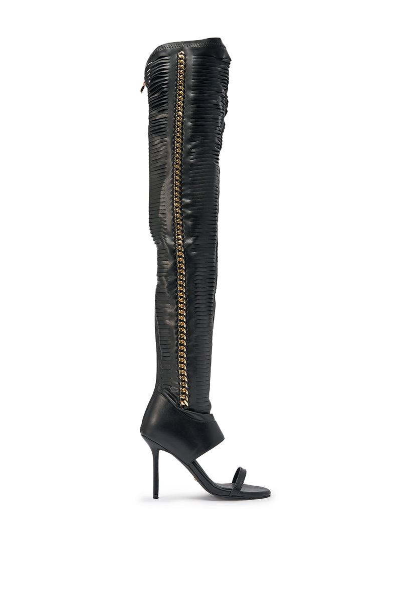 The AZALEA WANG ZARIE Black Thigh High Stretch PU Stiletto Boot features ruched material, an open toe, a gold chain detail on the side, and high heels for a bold look. 3