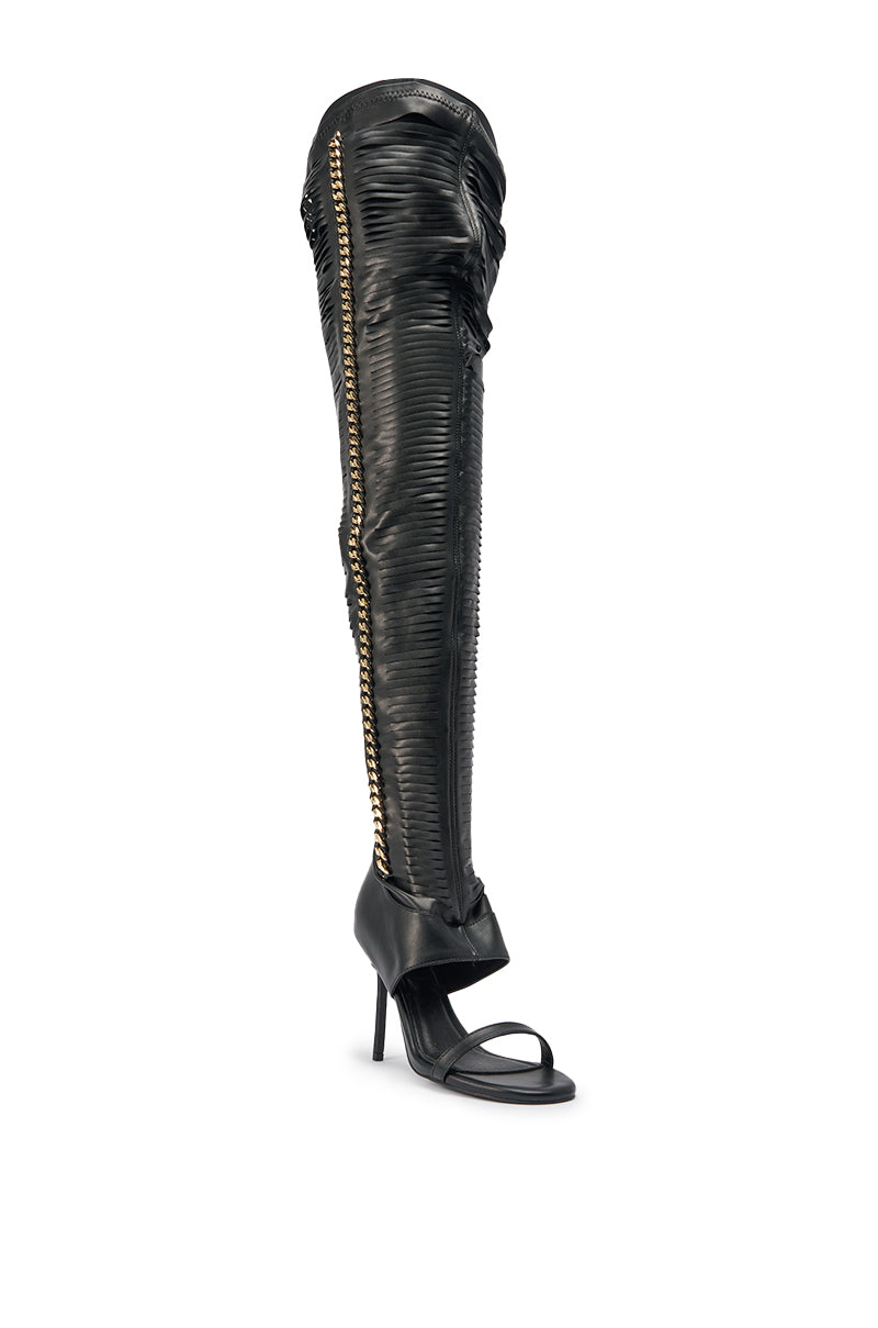 The AZALEA WANG ZARIE is a black thigh-high stretch PU stiletto boot featuring an open toe, ribbed texture, and bold gold embellishment along the side for a standout look. 4