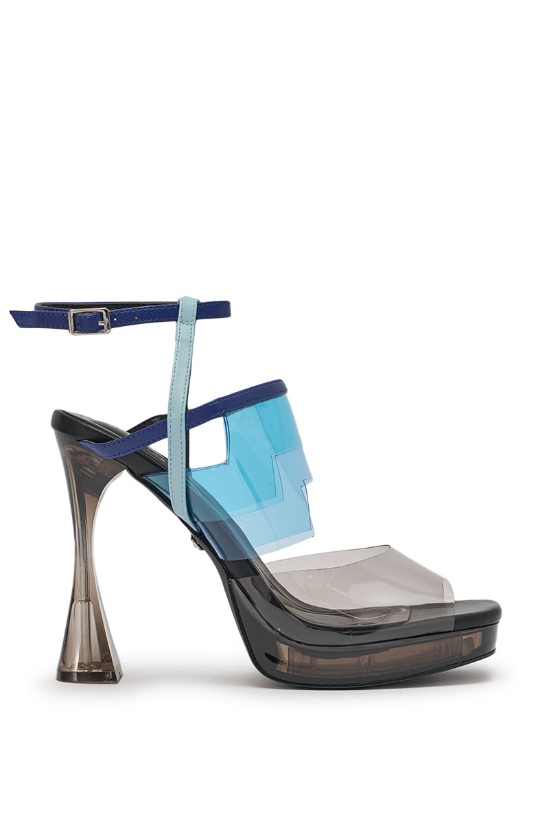 The AKIRA GOLD ZENAE BLUE MULTI PVC CHUNKY SANDAL features a blue faux leather platform sole, layered clear blue and gray straps, a sculptural flared heel, and a blue buckle ankle strap for a bold, modern geometric look. 4