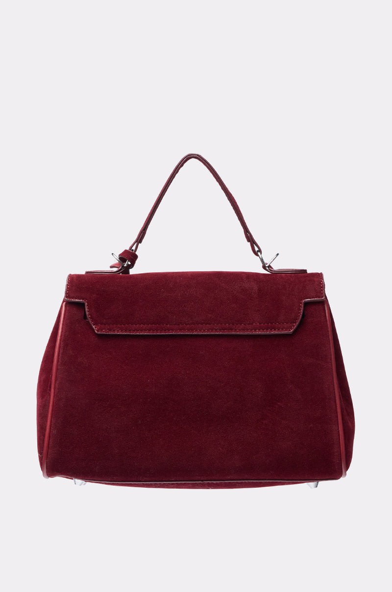 The TAKE ME TO DINNER SUEDE BAG is a burgundy faux suede structured bag with a single top handle and front flap closure, ideal for date night, shown against a plain light background. 2