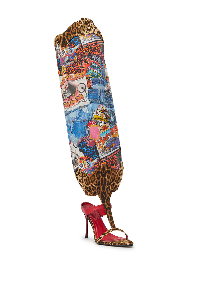 A leg-shaped sculpture features colorful collage art and leopard print, ending in the AKIRA GOLD ZIDANA DENIM MULTI BOOTIE WITH OPEN TOE—a thigh-high denim stiletto with a red pointed open toe—set against a white background. 4